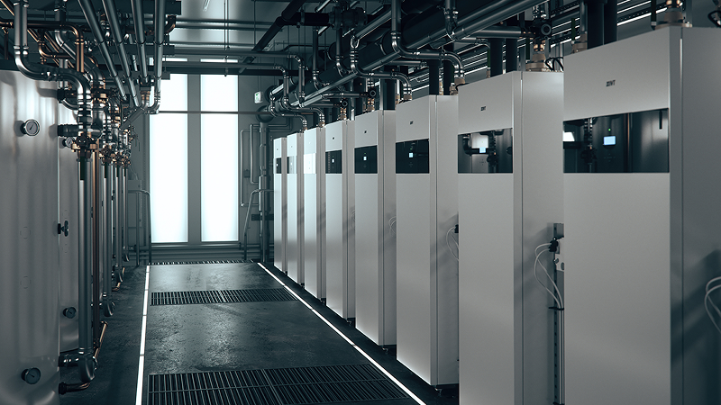 Industriellt pannrum med flera IVT värmepumpar installerade i rad och synliga rördragningar i taket.